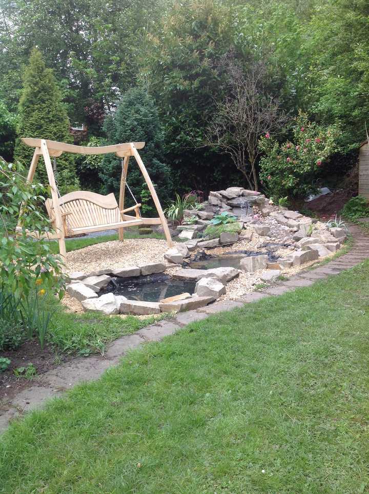 A swing seat in the community garden while the pond was being built