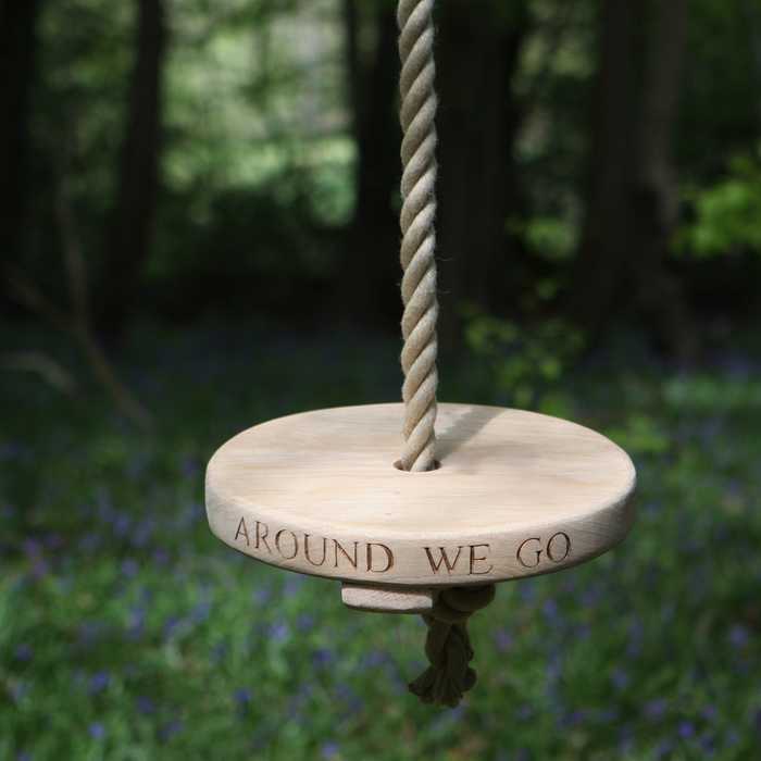 Sitting Spiritually Round Swing Seat hanging from a garden tree with inscription