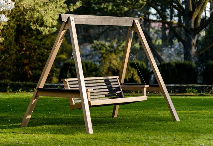 Modern swing seat in garden 