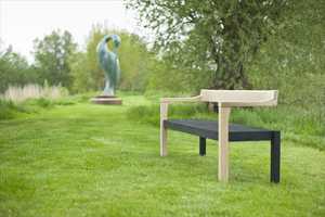The Floating Bench in scorched and natural oak. Photographed with ‘Isis’ by Simon Gudgeon at Sculpture by the Lakes