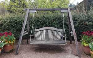 Tranquillity Oak Fan Back Swing seat at RHS Garden Rosemoor