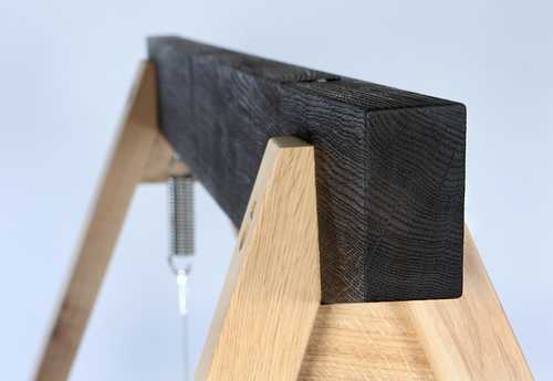 The contrasting top beam of a Yakisugi Swing Seat in scorched oak showing the stunning texture against the natural untreated oak