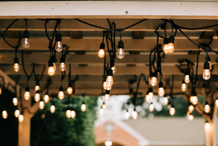 fairly lighting hanging from a pergola