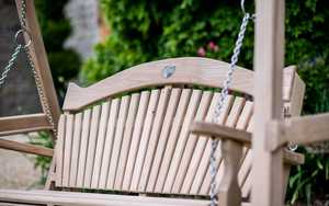 Curved Oak Garden Swing Seat with an ammonite close up