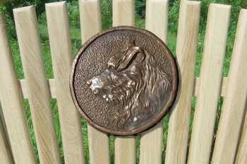 Plaque with a dog carved onto the surface
