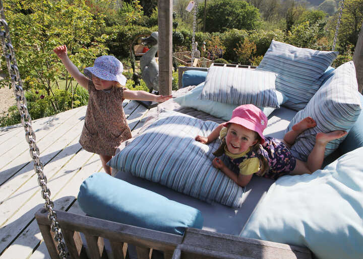 children-playing-on-swinging-day-bed.jpg