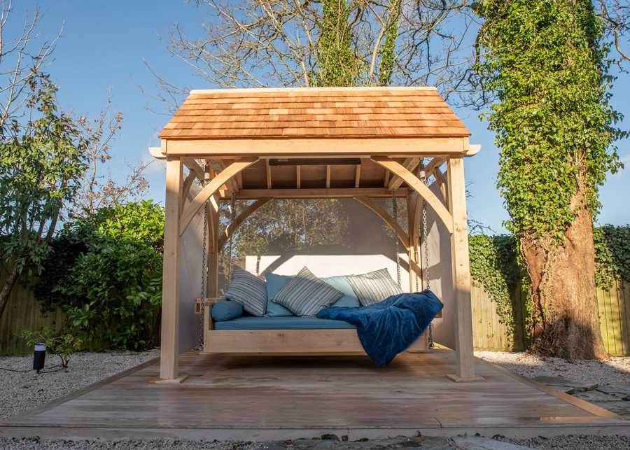 Outdoor Swinging Day Bed with roof in cedar wood