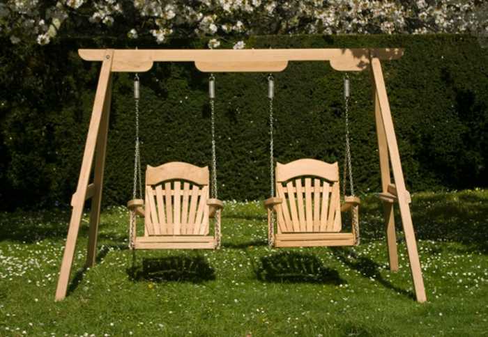 Two swing chairs on a lush lawn on our Trilogy frame