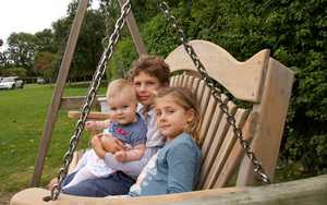 Family enjoying garden swing seat