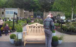 Sitting Spiritually Wooden Benches on display at RHS Harlow Carr