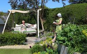 Curved Oak Swing Seat in Sitting Spiritually Show Garden
