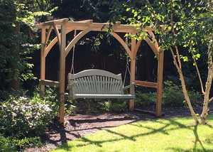 Pergola with Swing Seat situated in a garden