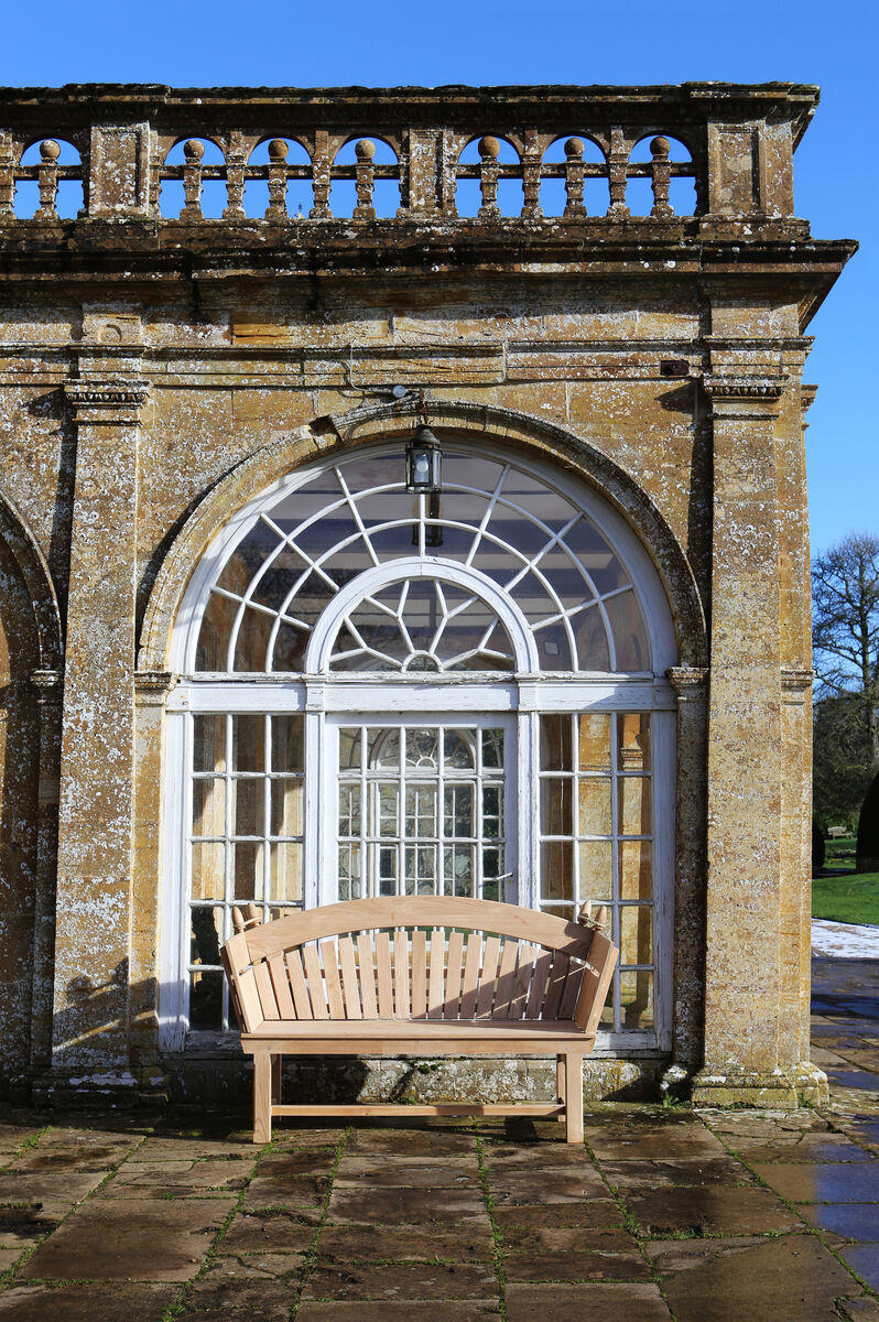 Sitting Spiritually knole bench against large glass window portrait 300 dpi.jpg