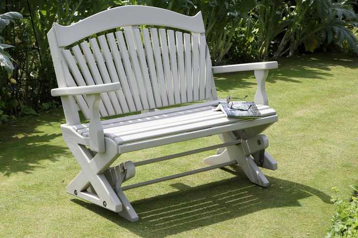 Painted rocking bench on lawn