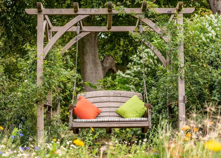 Pergola with swing seat and cushions