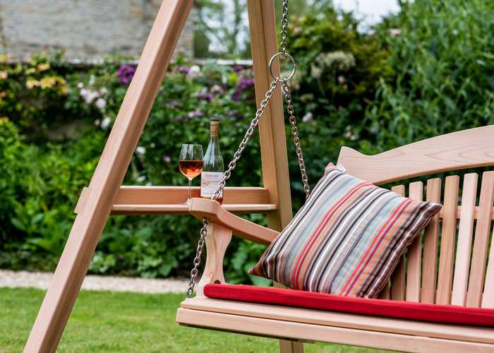 Close up of swinging seat with wine glass resting on a drinks shelf