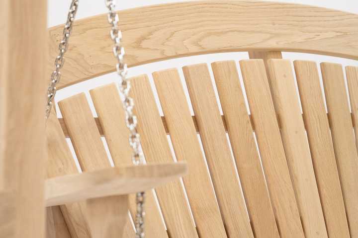 Swing seat in a garden with a pond