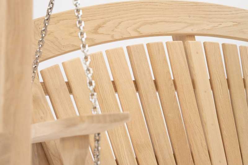 Swing seat in a garden with a pond