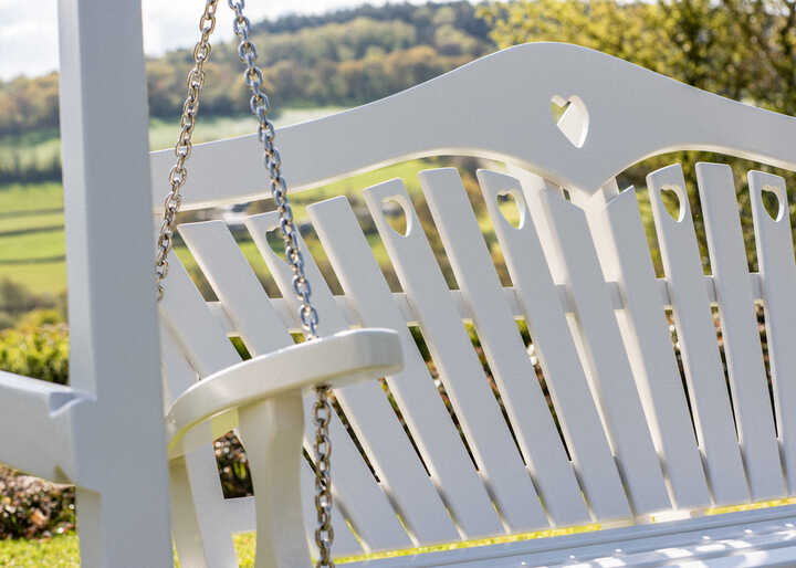 Should I choose wood or metal for my garden swing seat?