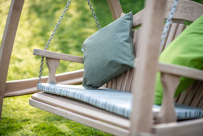 Close up of a garden swing seat with cushions