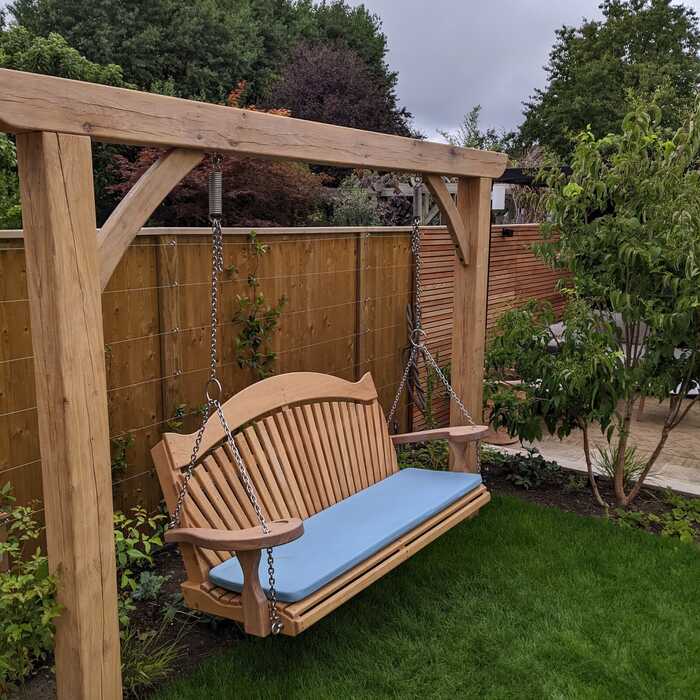 Two post pergola with hanging seat and cushion
