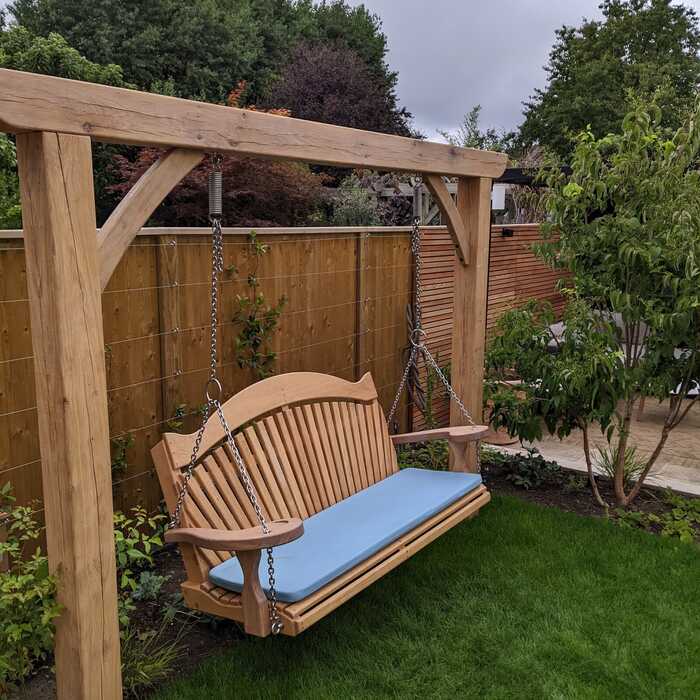 Two post pergola with hanging seat and cushion Two post pergola with hanging seat and cushion