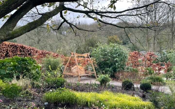 Sitting Spiritually Wooden Benches on display at RHS Harlow Carr
