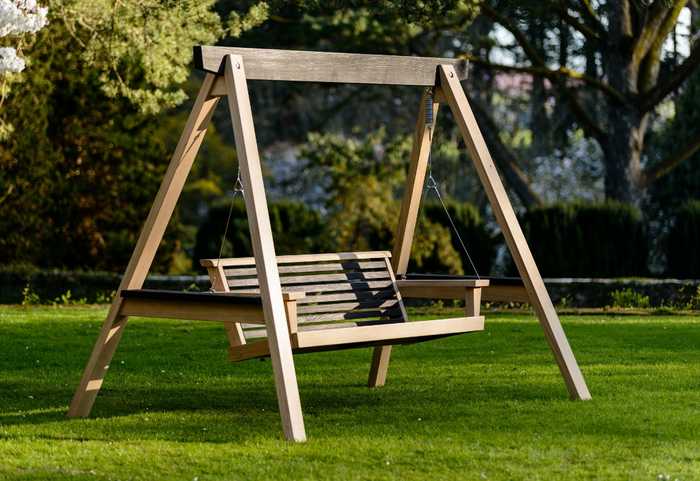 Modern swing seat in garden Modern swing seat in garden